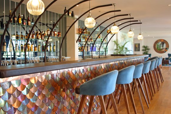 The group’s signature urban African style is seen in the bars clad in tiles or metallic fishtails.