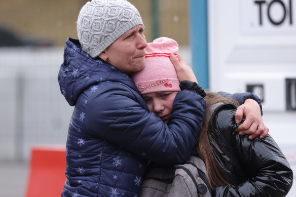 A mother and daughter fleeing war-torn Ukraine wait to cross into Poland.