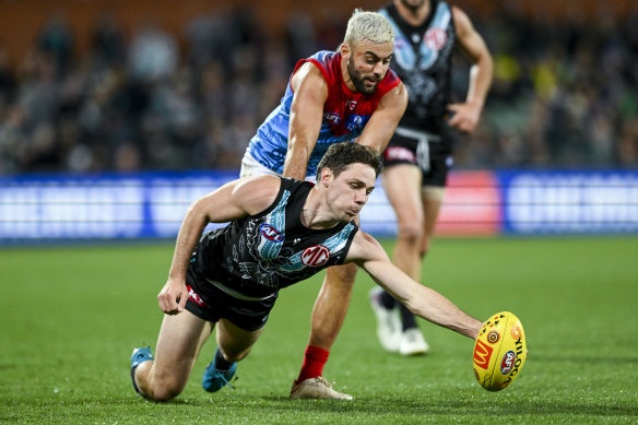 Jed McEntee of Port Adelaide competes with Melbourne’s Christian Salem at Adelaide Oval on Friday night.