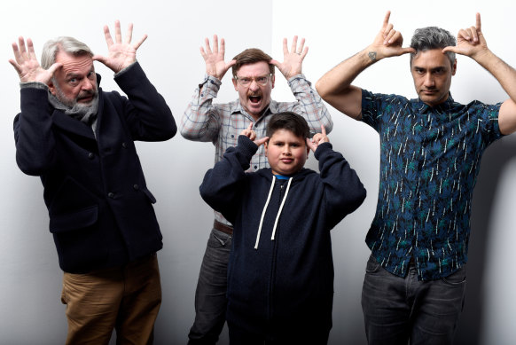 Waititi, at right, with Hunt for the Wilderpeople actors, from left, Sam Neill, Rhys Darby and Julian Dennison.