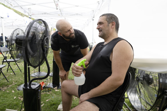Dr Timothy English (left) with Pat Raso, who says he’ll probably stay at the cooling hub all day to beat the heat. 