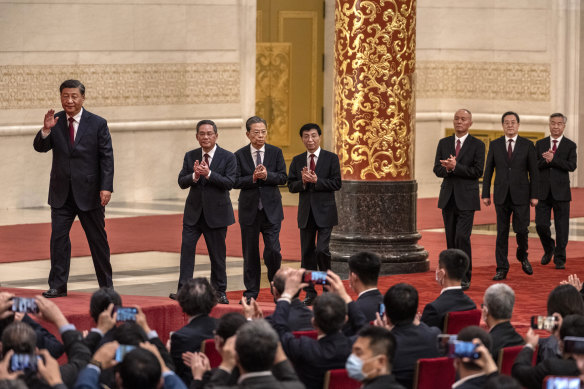 Xi Jinping, left, unveils his new team led by Li Qiang, second from left, in the Great Hall of the People in 2022.
