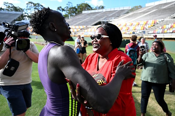Gout Gout is embraced by his mother Monica Gout after his win in the 200m.