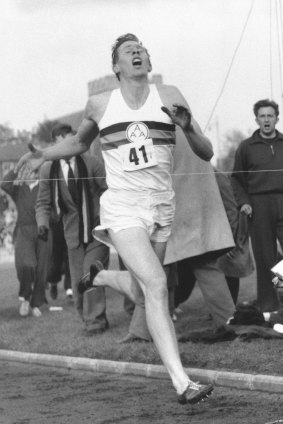 Roger Bannister hits the tape to break the four-minute mile in Oxford, England.