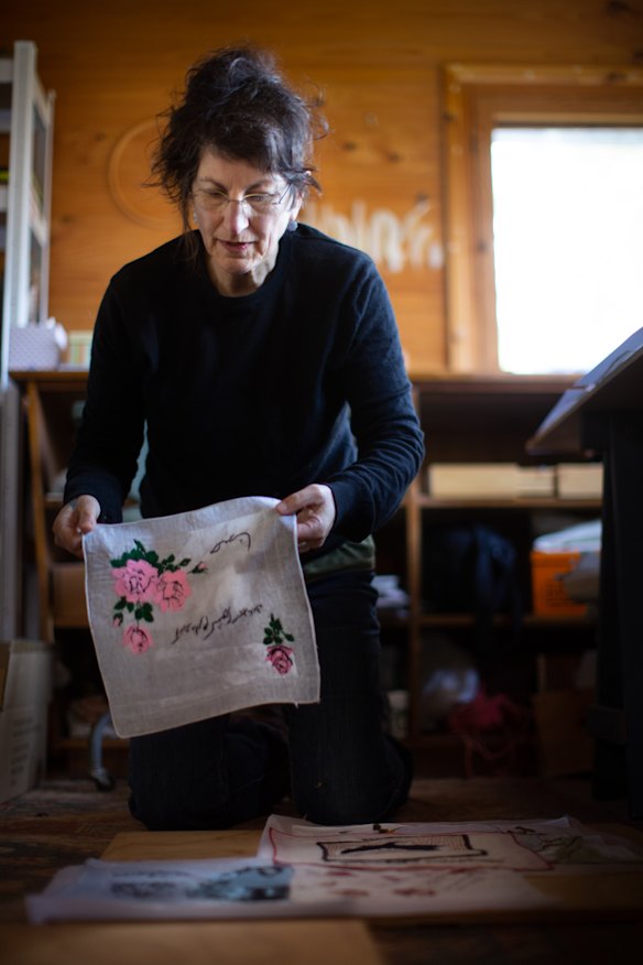 Gali Weiss with examples of the handkerchief artworks created for <i>Making Marks</i>.
