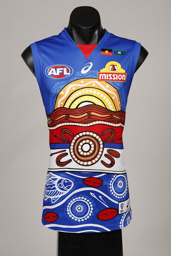 Brett Goodes is from the Adnyamathanha & Narungga people (South Australia), who are represented in the artwork with the sun rising on Akurra (giant water snake) moving and shaping the Ranges around him.