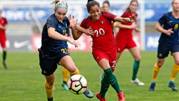 Ellie Carpenter battles for the ball with Jessica Silva of Portugal.