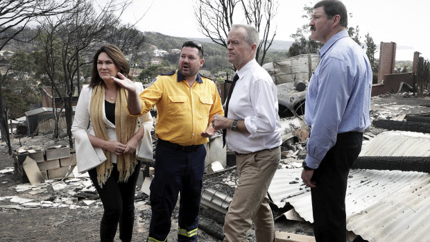 RFS Inspector Ben Shepherd briefs Labor Senator Deborah O'Neill, Opposition Leader Bill Shorten and Labor MP Mike Kelly in the aftermath of the Tathra bushfire.