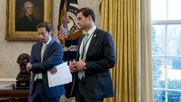 Former aide to Donald Trump, John McEntee, right, has left his role in the White House over a security issue.