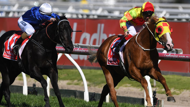 Michael Walker rides Mighty Boss (right) to victory in the Caulfield Guineas.