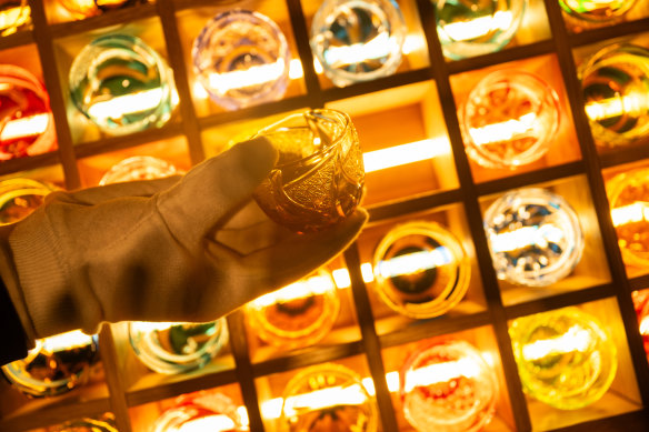 A white-gloved sommelier selects a  glass from Japan’s famous Kagami Crystal.