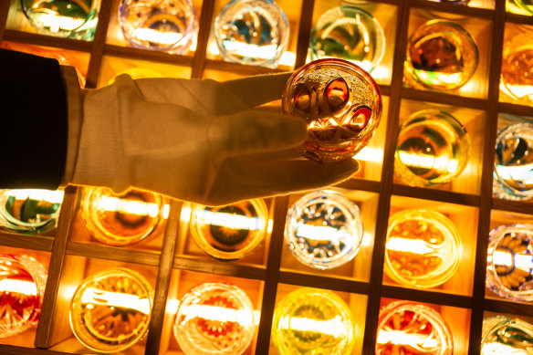 A white-gloved sommelier selects a glass of Japan's famous Kagami Crystal.