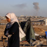 Smoke rises following an Israeli airstrike on buildings near the separating wall between Egypt and Rafah.