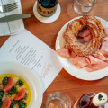 Trophy Room’s kingfish crudo with grapefruit and green chilli (left) and cacio e pepe cruller with mortadella.