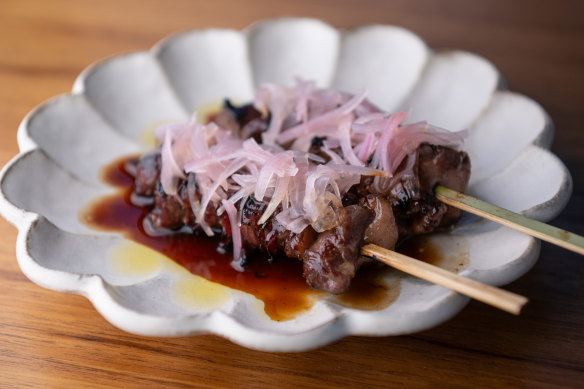 Teriyaki-glazed wagyu rump cap skewers topped with pickled shallots.