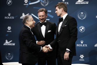 FIA president Jean Todt, left, shakes hands with Max Verstappen as Red Bull team chief Christian Horner looks on at the FIA prize-giving ceremony in Paris on Thursday.