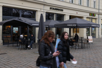 People walk past a Starbucks cafe in Berlin, Germany, where infections appear to be peaking.