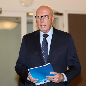 Dutton arrives at the press conference.