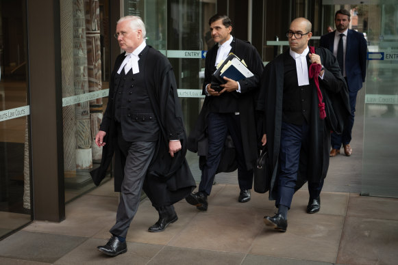 Bret Walker SC (left), and colleagues Arthur Moses, SC, and Phillip Sharp leave the Federal Court in Sydney on Monday.