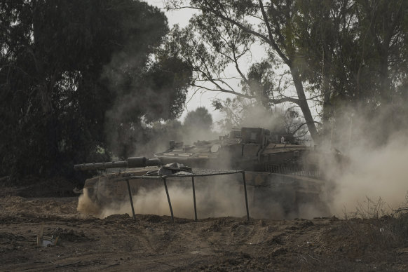 An Israeli tank moves along the border with the Gaza Strip in southern Israel on Thursday. The ceasefire is due to start on Sunday.