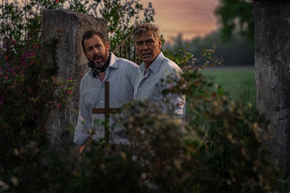 Adam Sandler (left) plays George Clooney’s loyal manager, Ron. 