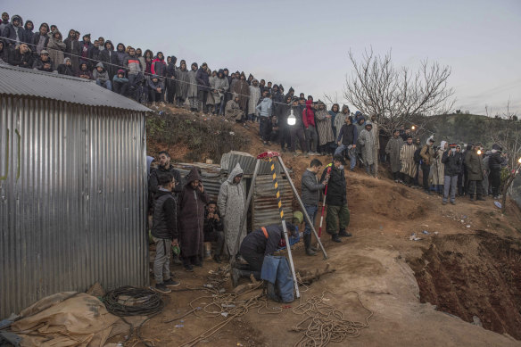 Residents watch as authorities attempt to rescue a 5 year old boy who fell into a hole in Morocco. 