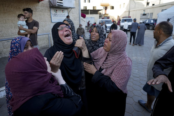 Palestinians mourn for relatives killed in the Israeli bombardment of the Gaza Strip at a hospital morgue in Deir al-Balah on Wednesday morning, local time.