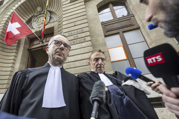 Lawyers of the accused, Nicolas Jeandin, left, and Robert Assael, right, leave the court house after a break in the reading of the verdict in Geneva, Switzerland.