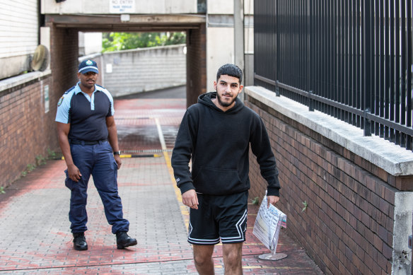 Alleged Wakeley rioter Dani Mansour leaves Blacktown Local Court after being released on bail.