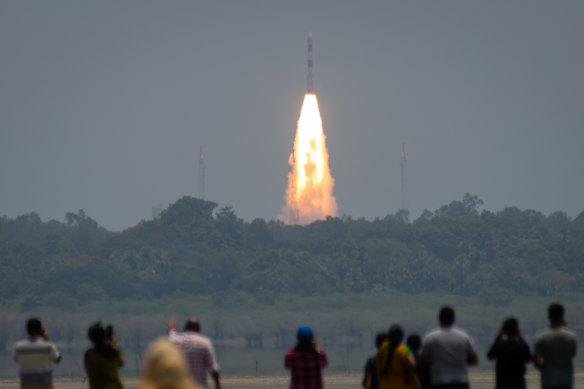 People watch the ISRO rocket lift-off in Sriharikota, India. 