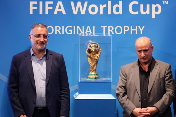 President of the Iranian Football Federation, Mehdi Taj (right) poses for a photo with the FIFA World Cup trophy in May with the mayor of Tehran, Alireza Zakani.