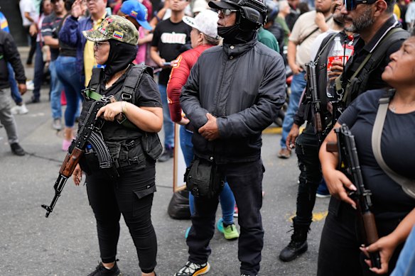 Pro-government armed civilians attend a protest in Caracas on Sunday.
