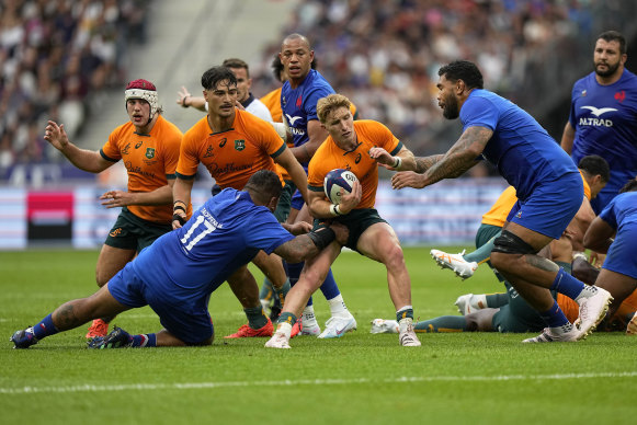 Australia’s Tate McDermott runs the ball against France. 