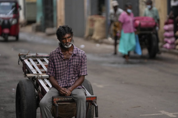 A daily wage laborer waits for work at a wholesale market in Colombo, Sri Lanka on Monday. The country is experiencing crippling food and fuel shortages.