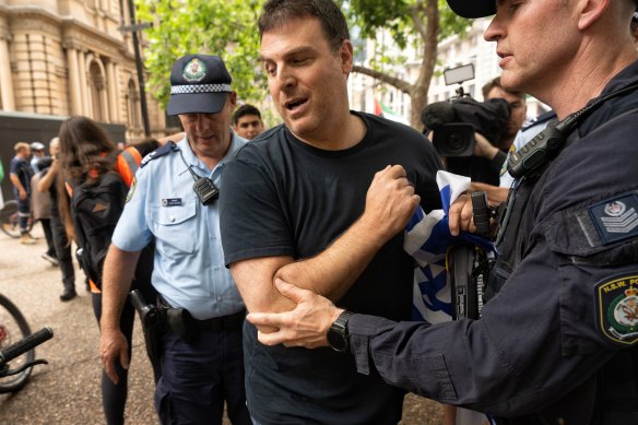 An Israeli supporter was led away by police at the protest for allegedly breaching the peace.