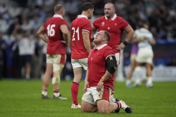Wales players react after losing the Rugby World Cup quarterfinal match against Argentina.