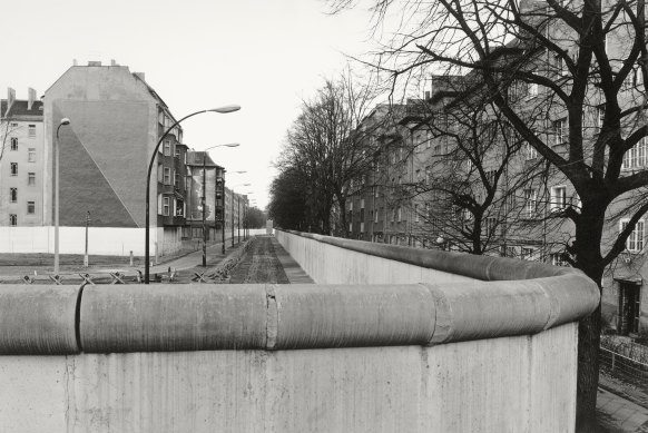 The Wall completely cut off West Berlin from surrounding East Germany and from East Berlin until government officials opened it in November 1989.
