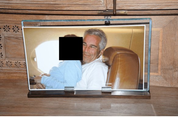 A framed photograph of Epstein with a female on his lap, documented during a search of his home on Little Saint James island in 2019.