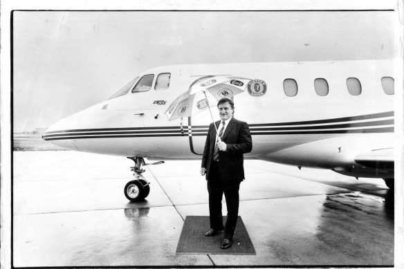 John Elliott with the IXL company jet at Essendon Airport in 1987.