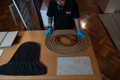 Staff from the Museums of History NSW unload exhibits including a noose, black hood worn by the condemned and a letter from Louisa Collins.
