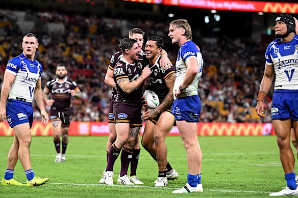 Broncos' Xavier Willison celebrates with his teammates after scoring against the Bulldogs at Suncorp Stadium.