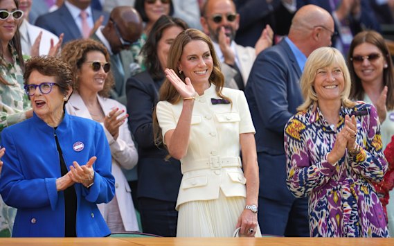 The Princess of Wales waves to the crowd, flanked by Billie Jean King (left) and All England club chair Debbie Jevans.