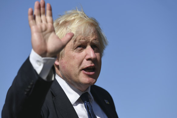 Boris Johnson waves during his meeting with Volodymyr Zelensky.