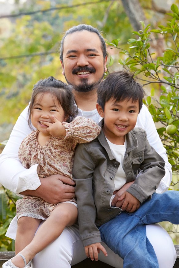Anna, 2, said, " I love it when daddy reads books." She is here with Adam and 4-year-old Christopher. 