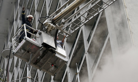 A trapped employee is rescued from the Manila Pavilion Hotel.