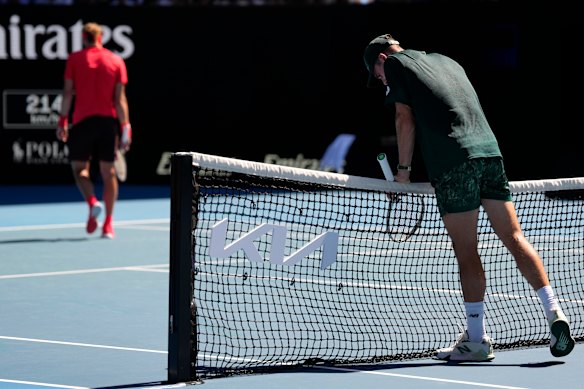 Tommy Paul of the US rests on the net during the quarter-final with Alexander Zverev.