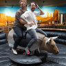 Owners Josh Uljans (left) and Karl van Buuren ride the mechanical bull at Moon Dog Brewery in Footscray.