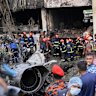 Firemen look for the survivors after a Bangladesh Air Force training aircraft that crashed onto a school campus.