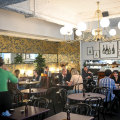 Pope Joan’s interior features a chandelier and golden wallpaper.