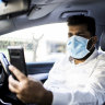A DiDi driver taking a mask compliance selfie.